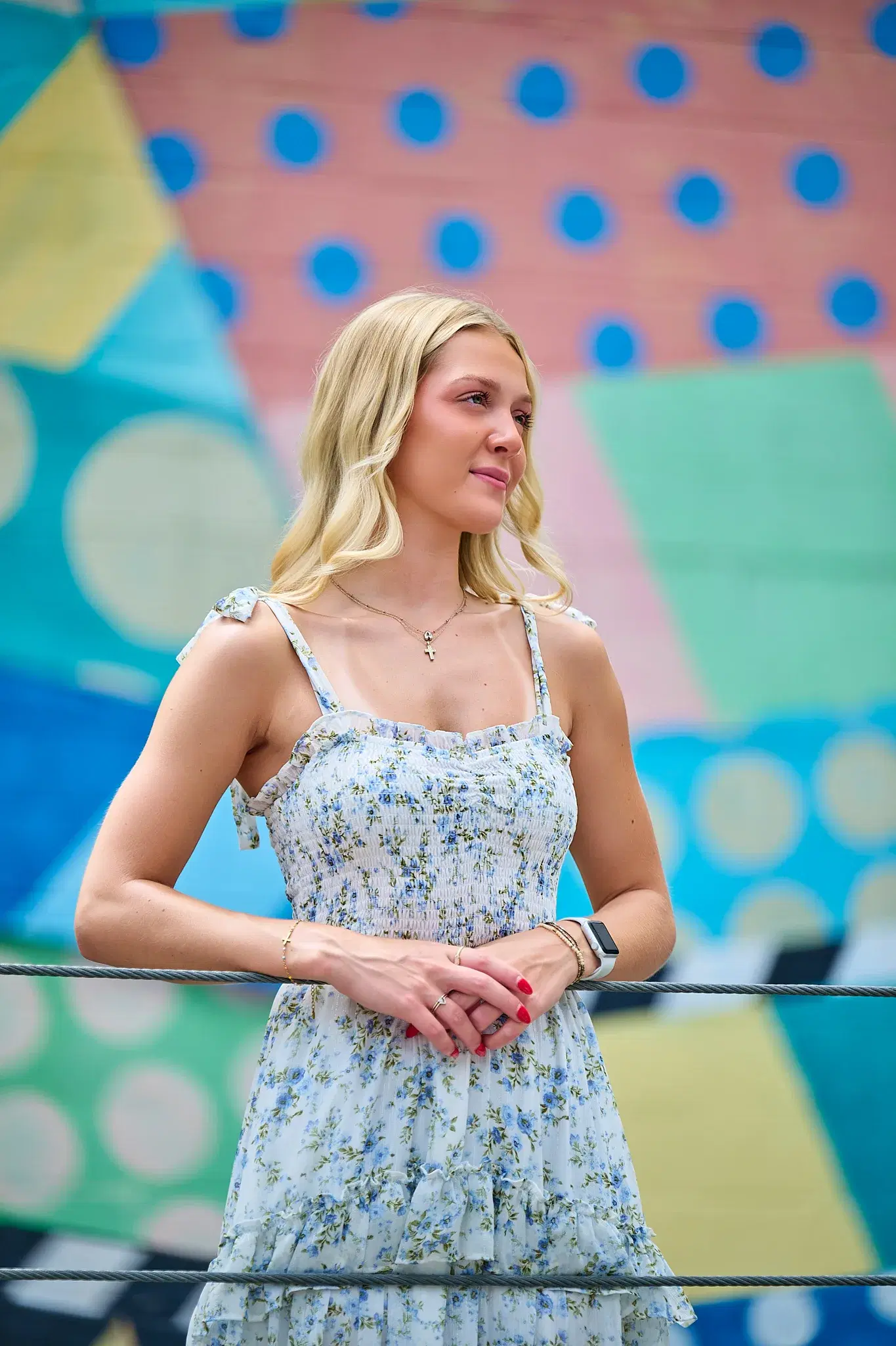 Professional portrait against vibrant pink and blue Nashville mural backdrop